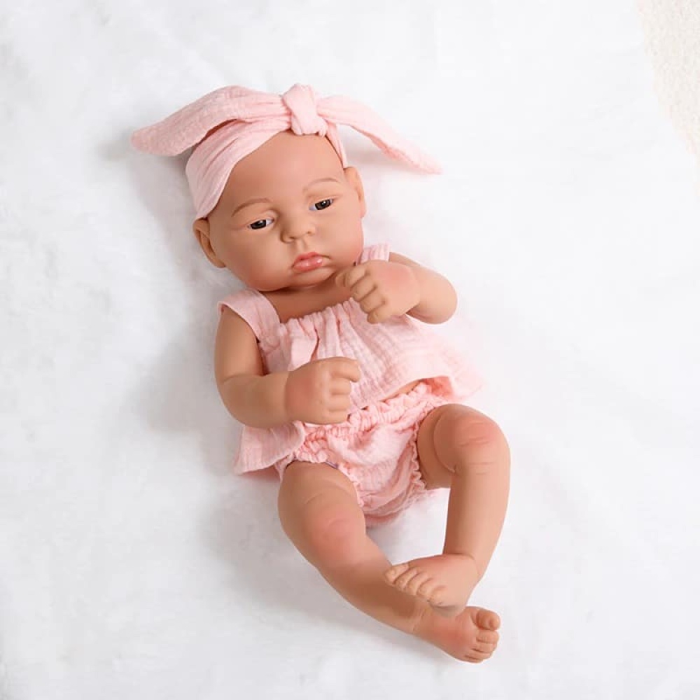Neugeborene Silikonpuppe für Kinder mit rosa Kleid und Kopfband
