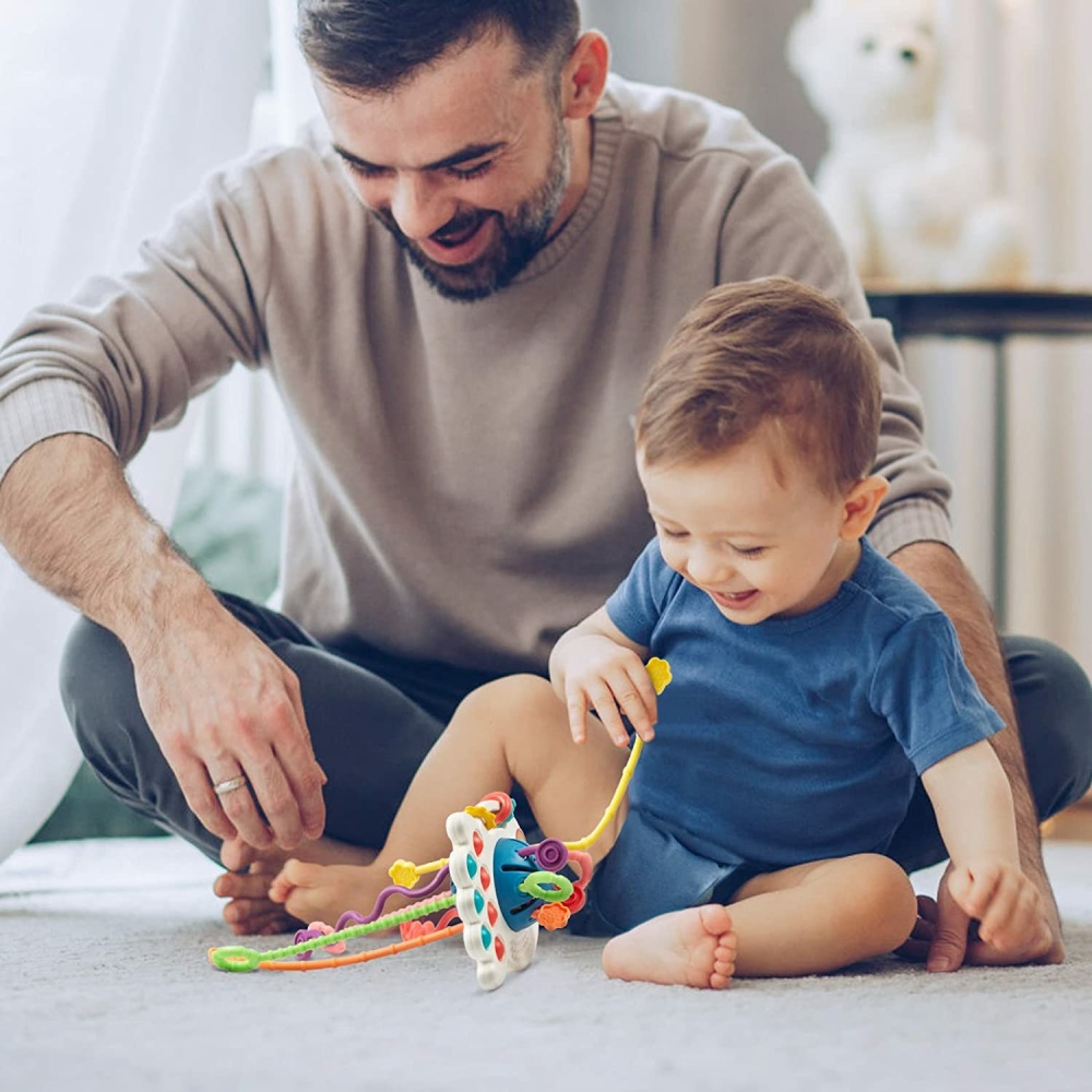 Montessori Silikon-Beißspiel für Babys mit Hintergrund, ein Vater mit seinem Baby