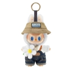 Weiße Labubu-Plüschfigur mit beigem Hut, Latzhose aus Jeansstoff und weißer Blume.